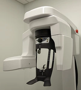 Digital panoramic dental X-ray machine for full-mouth imaging at modern dentist office.